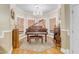 Elegant piano room with a grand piano, chandelier, and large windows for natural light at 616 E Carver Rd, Tempe, AZ 85284