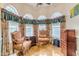 Sitting area with hardwood floors, traditional furniture, decorative windows, and custom draperies at 616 E Carver Rd, Tempe, AZ 85284