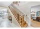 Classic staircase with wooden steps and white banisters, connecting different levels of the home at 616 E Carver Rd, Tempe, AZ 85284