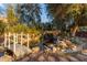 Scenic pond with bridge, waterfall, lush greenery, and artistic statuary creating a tranquil garden escape at 616 E Carver Rd, Tempe, AZ 85284