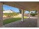 A covered patio overlooks a backyard with manicured artificial grass and string lights at 6516 W Matilda Ln, Glendale, AZ 85308