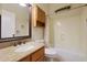 Bathroom features a vanity with granite countertop, framed mirror, and shower-tub combo at 6516 W Matilda Ln, Glendale, AZ 85308