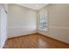 Bedroom with wood floors, plantation shutters, and white trim at 6516 W Matilda Ln, Glendale, AZ 85308