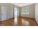 Bedroom with wood floors, decorative shelving, and white plantation shutters at 6516 W Matilda Ln, Glendale, AZ 85308