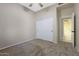 Neutral bedroom features a closet with white sliding doors and adjoining bathroom at 6516 W Matilda Ln, Glendale, AZ 85308