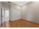 Bedroom with wood floors, sliding closet doors and doorway to bathroom at 6516 W Matilda Ln, Glendale, AZ 85308