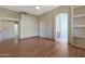 Spacious bedroom featuring wood floors, hallway, and doorway to a bath at 6516 W Matilda Ln, Glendale, AZ 85308