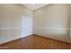 Bedroom with wood floors, sliding closet doors, and white trim at 6516 W Matilda Ln, Glendale, AZ 85308