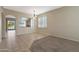 Spacious dining room features tile flooring, decorative chandelier, and arched entryway to kitchen at 6516 W Matilda Ln, Glendale, AZ 85308