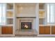 Close-up of the fireplace with built-in shelving on each side and tile surround at 6516 W Matilda Ln, Glendale, AZ 85308