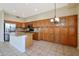 Bright kitchen features a large island, stainless steel appliances, and custom wood cabinets at 6516 W Matilda Ln, Glendale, AZ 85308