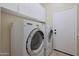 Bright laundry room featuring washer, dryer, white cabinets, and tiled floor at 6516 W Matilda Ln, Glendale, AZ 85308