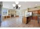 Open concept space featuring a living area, fireplace, and bright kitchen at 6516 W Matilda Ln, Glendale, AZ 85308