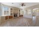 Cozy living room with a fireplace, built-in shelves, and tile flooring throughout at 6516 W Matilda Ln, Glendale, AZ 85308