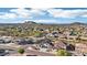 Elevated shot capturing neighborhood charm and beautiful mountain views in a suburban community at 7318 W Paso Trl, Peoria, AZ 85383