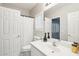 Bright bathroom with a white vanity, large mirror, and a shower with a white curtain at 7318 W Paso Trl, Peoria, AZ 85383