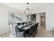 Open dining room with a dark wood table and modern chandelier at 7318 W Paso Trl, Peoria, AZ 85383