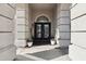 Grand front entrance features textured pillars and black double doors at 7318 W Paso Trl, Peoria, AZ 85383