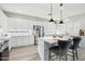 Modern kitchen with stainless steel appliances, white cabinetry, and a center island at 7318 W Paso Trl, Peoria, AZ 85383