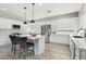 Modern, all-white kitchen with a center island and stainless steel appliances at 7318 W Paso Trl, Peoria, AZ 85383