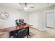 Spacious home office featuring a large desk, ceiling fan, and plenty of natural light at 7318 W Paso Trl, Peoria, AZ 85383