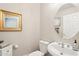 Cozy powder room featuring a sink with a pedestal base and a gold-framed mirror at 7318 W Paso Trl, Peoria, AZ 85383