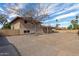 Spacious backyard featuring gravel landscaping, a patio, and mature shade trees at 7539 N 50Th Ave, Glendale, AZ 85301