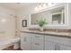 Bright bathroom with granite counters, dual sinks and a shower-tub combo at 7539 N 50Th Ave, Glendale, AZ 85301