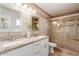 Elegant bathroom featuring a double sink vanity, tiled shower, and neutral decor at 7539 N 50Th Ave, Glendale, AZ 85301