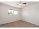 Comfortable carpeted bedroom with natural light from large windows and a ceiling fan at 7539 N 50Th Ave, Glendale, AZ 85301