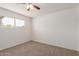 Bright bedroom with neutral carpet, ceiling fan, and natural light at 7539 N 50Th Ave, Glendale, AZ 85301