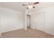 Bedroom featuring neutral carpet, a ceiling fan, large closet and access to adjoining bathroom at 7539 N 50Th Ave, Glendale, AZ 85301