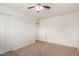 Neutral bedroom featuring a ceiling fan, closet and adjoining bathroom at 7539 N 50Th Ave, Glendale, AZ 85301