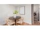 Bright dining area with wood floor, statement lighting, a round table with modern chairs and a washer/dryer closet at 7539 N 50Th Ave, Glendale, AZ 85301