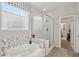 Modern bathroom with a luxurious soaking tub, glass-enclosed shower, and stylish tile accents at 7924 S 24Th Pl, Phoenix, AZ 85042