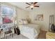 Bright bedroom with a view of flowers and a patterned bedspread at 7924 S 24Th Pl, Phoenix, AZ 85042