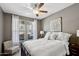 Cozy bedroom with a ceiling fan, decorative wall art, and ample natural light at 7924 S 24Th Pl, Phoenix, AZ 85042