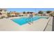 Community pool with shallow entry and seating, surrounded by neighborhood homes at 7924 S 24Th Pl, Phoenix, AZ 85042