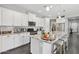 Spacious kitchen featuring granite counters, white cabinetry, and modern stainless appliances at 7924 S 24Th Pl, Phoenix, AZ 85042