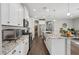 Bright kitchen featuring granite countertops, white cabinetry, and stainless steel appliances at 7924 S 24Th Pl, Phoenix, AZ 85042