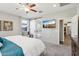 Comfortable bedroom with TV, stylish sliding barn door leading to an ensuite bathroom at 7924 S 24Th Pl, Phoenix, AZ 85042