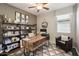 Stylized home office with a rustic desk, shelving, comfortable chair, and neutral tones at 7924 S 24Th Pl, Phoenix, AZ 85042