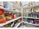 Organized pantry featuring an array of shelves stocked with a variety of food items and kitchen essentials at 7924 S 24Th Pl, Phoenix, AZ 85042