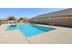 Community pool with a blue tile trim, ladder access, and concrete surround at 7924 S 24Th Pl, Phoenix, AZ 85042