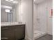 Modern bathroom featuring a vanity, mirror, and a glass-enclosed walk-in shower with marble tile at 8 Biltmore Est # 212, Phoenix, AZ 85016