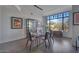 This dining room is bright with hardwood floors and a large window with backyard views at 8 Biltmore Est # 212, Phoenix, AZ 85016