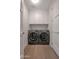 Convenient laundry room with modern washer and dryer units, white cabinets, and ample storage at 8 Biltmore Est # 212, Phoenix, AZ 85016