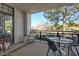 Spacious covered outdoor patio with seating and view of trees and landscaping at 8 Biltmore Est # 212, Phoenix, AZ 85016