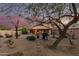 Backyard with mature trees, barbecue, and a decorative layout ideal for outdoor relaxation at 80 S Maple Ct, Chandler, AZ 85226