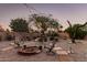 Inviting backyard with a charming fire pit and ample seating under the soft glow of string lights at 80 S Maple Ct, Chandler, AZ 85226